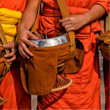 Participate in a traditional alms-giving ceremony